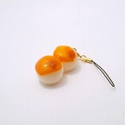 toasted_dumplings_covered_in_a_soy_and_sugar_sauce_cell_phone_charm_zipper_pull
